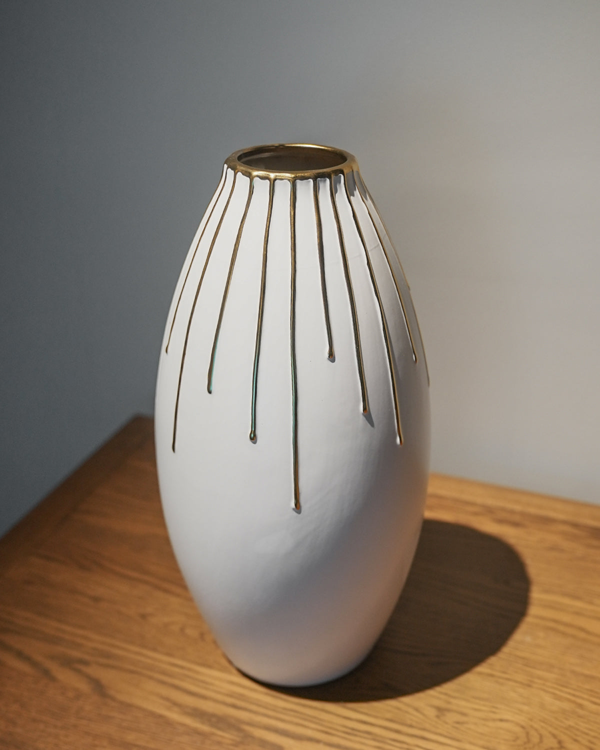 White and golden lined vase
